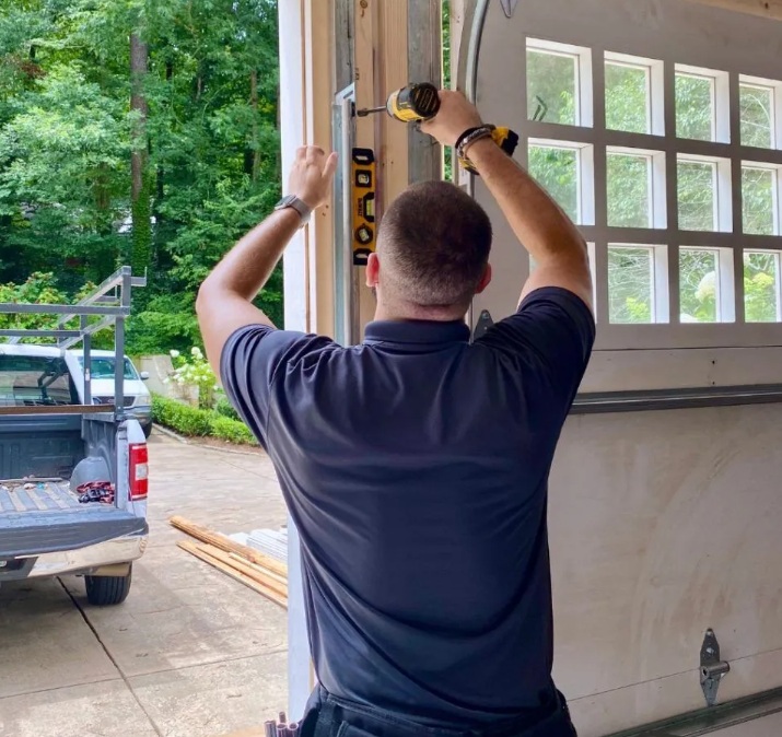 Garage door technician checking hardware